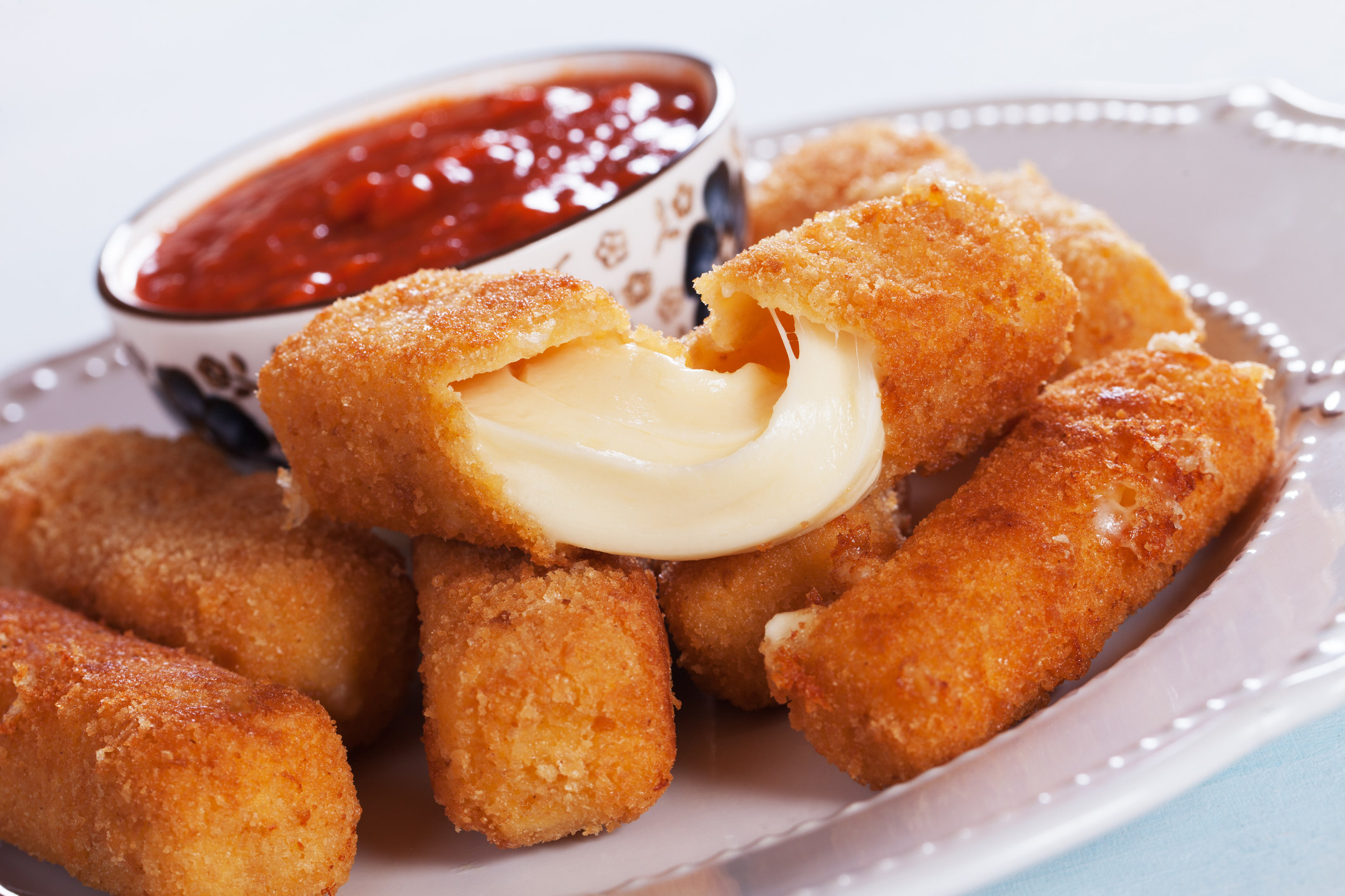 Mozzarella sticks on a plate.