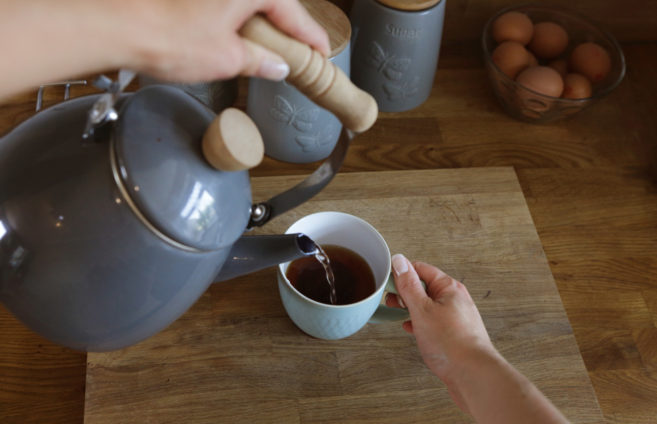 Pouring water from a kettle.