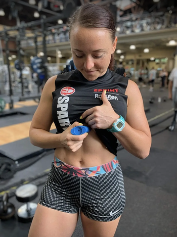 Model applying it under a sports bra 