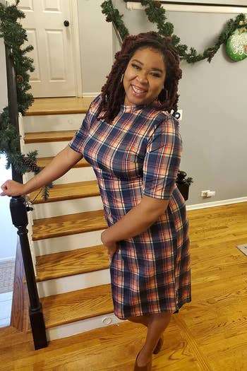 reviewer wearing the dress in navy, red, and yellow plaid