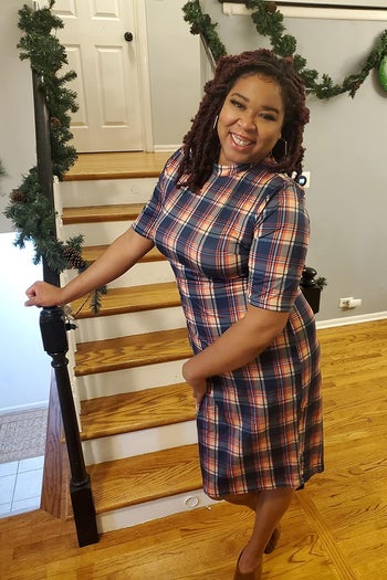 reviewer wearing the dress in navy, red, and yellow plaid