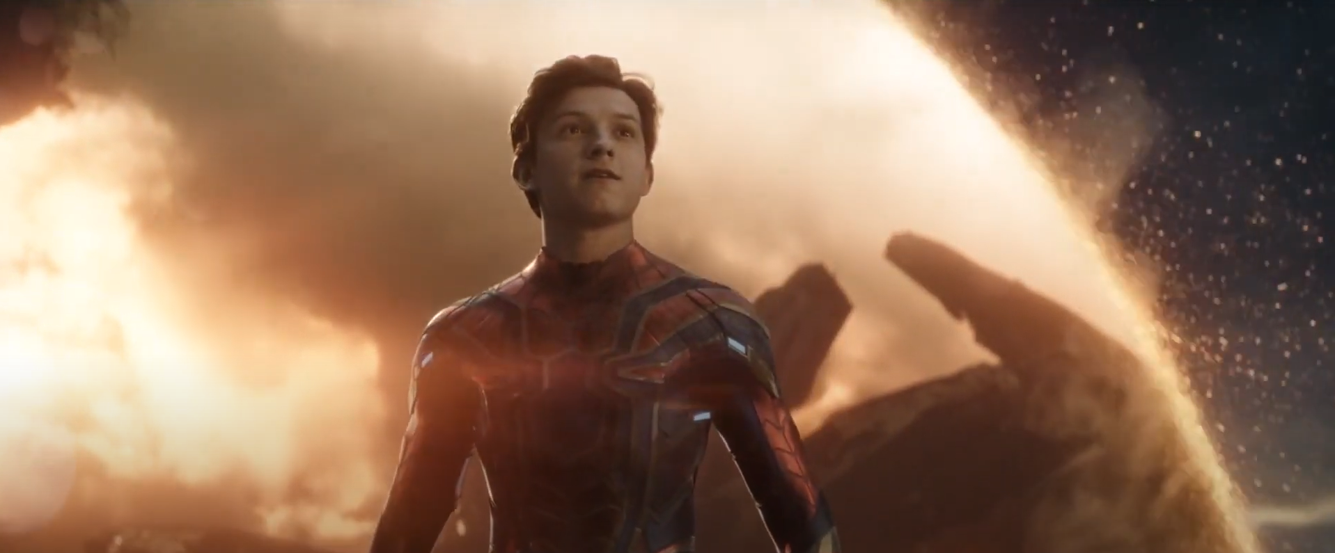 peter parker stands in front of an explostion