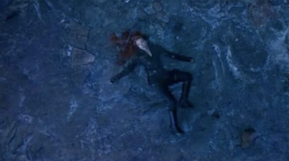 black widow lies at the bottom of a cliff