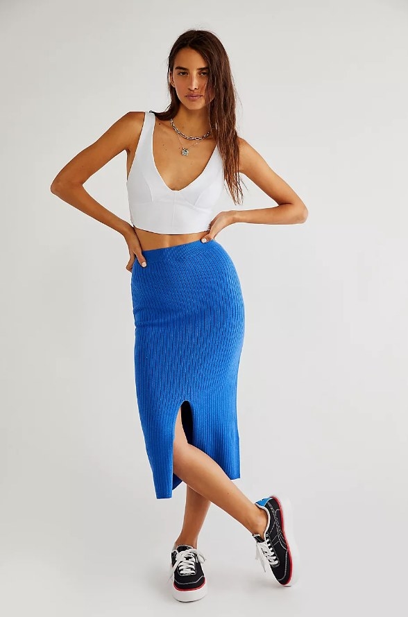 Model wearing ribbed blue midi skirt with bottom slit