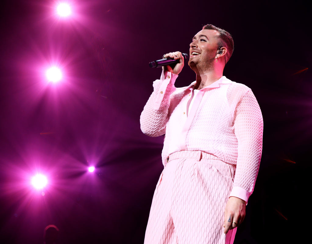 Sam Smith singing onstage in an all-pink outfit