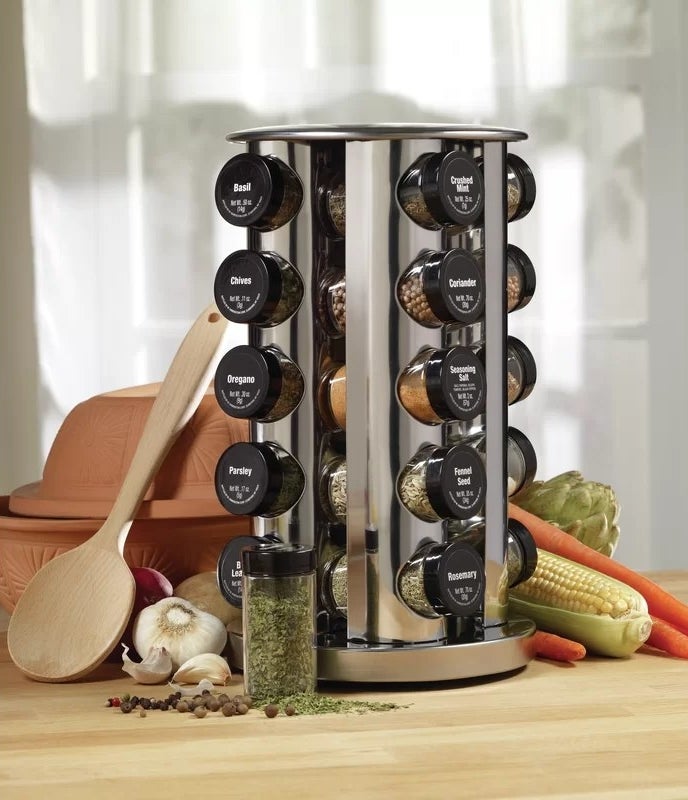 The rotating spice rack filled with spice jars on a kitchen counter