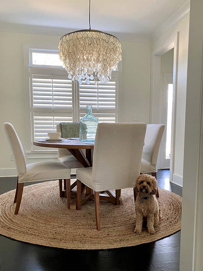 Reviewer&#x27;s circular rug is shown in the dining room