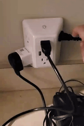 Reviewer turning the light on and off the charger with items plugged in 