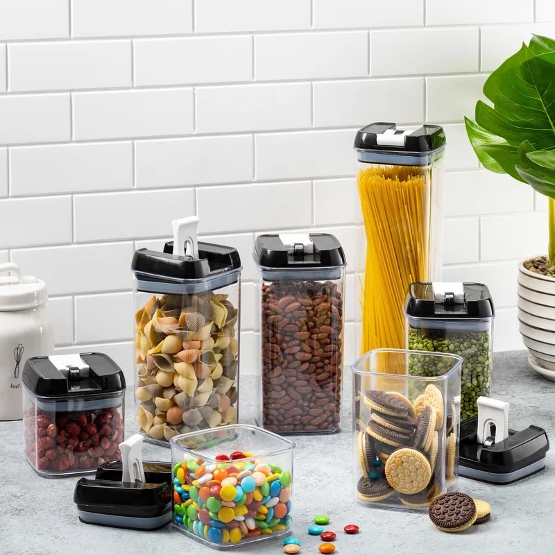 The canister set storing various foods on a kitchen counter