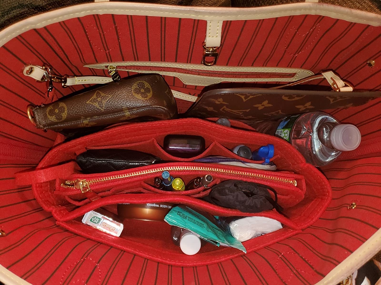 a reviewer photo of the inside of their purse organizer with the pocketed insert