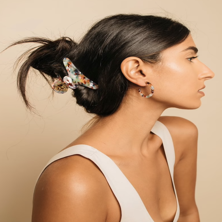 A model wearing the claw in a bun 