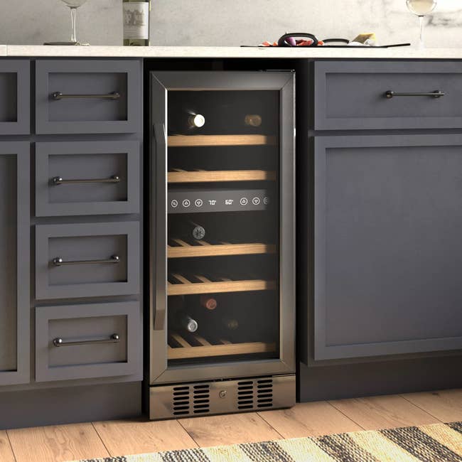 The wine fridge underneath a kitchen counter