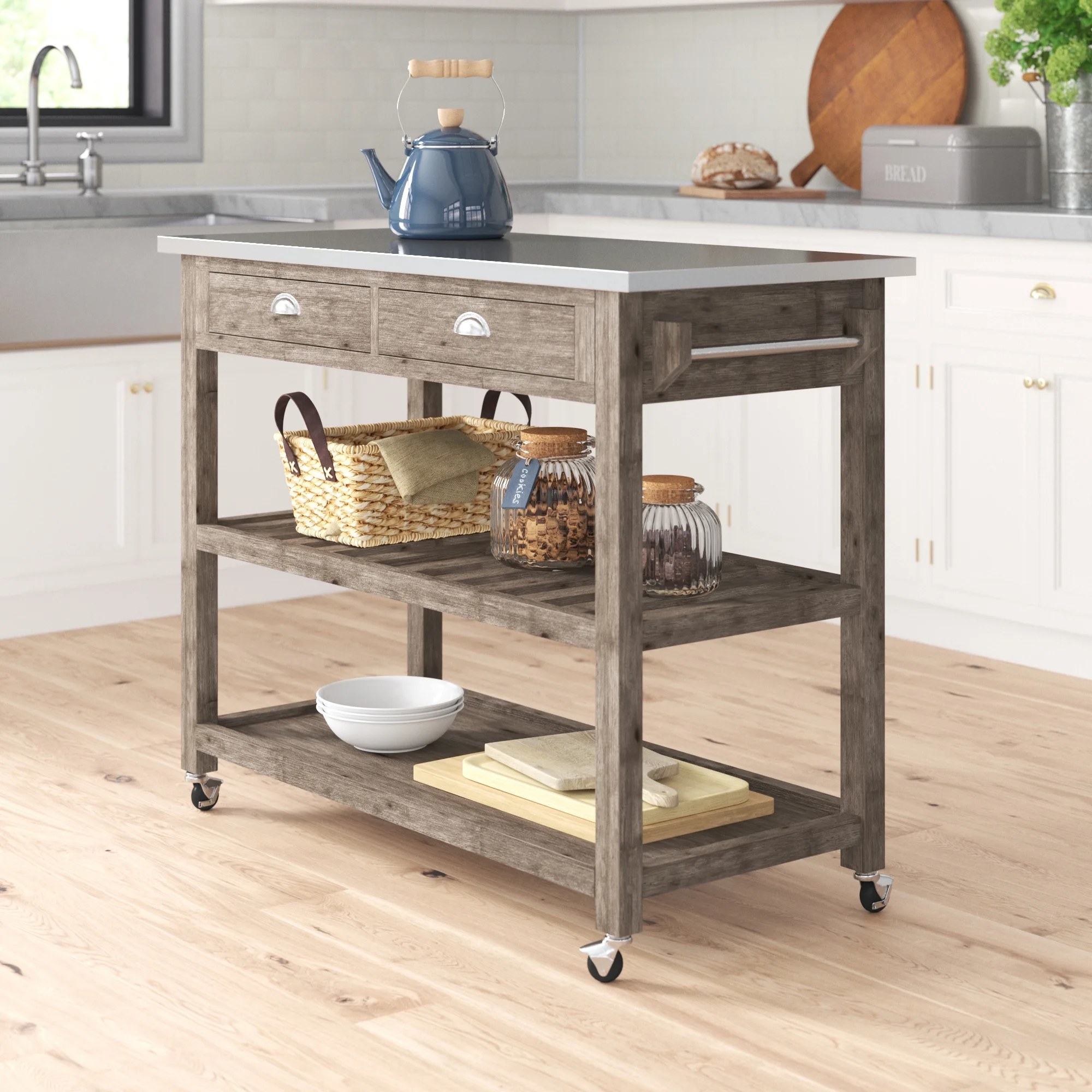 The kitchen cart on wheels with two shelves and a stainless steel surface