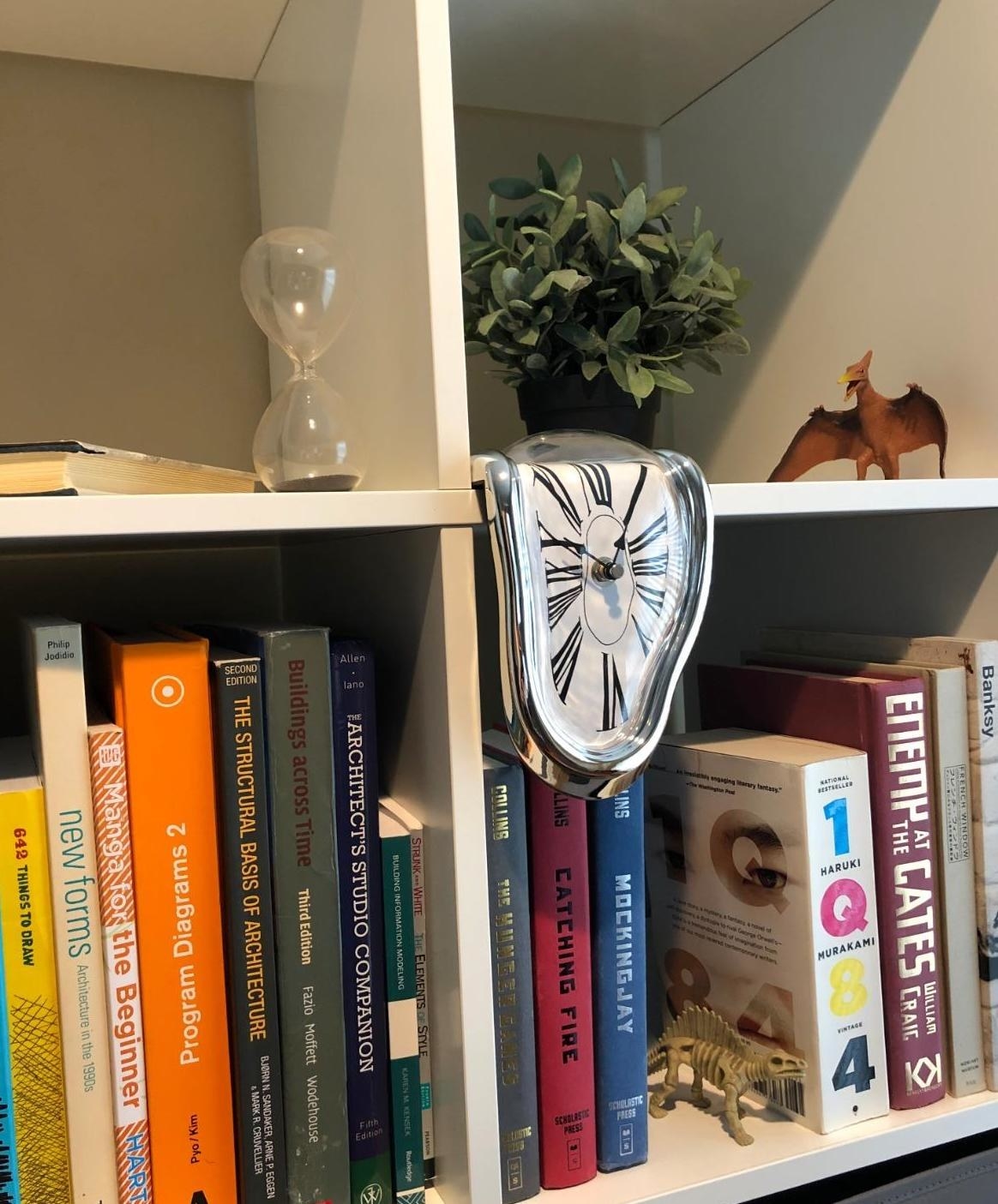 Reviewer's Dali clock is displayed on a bookcase