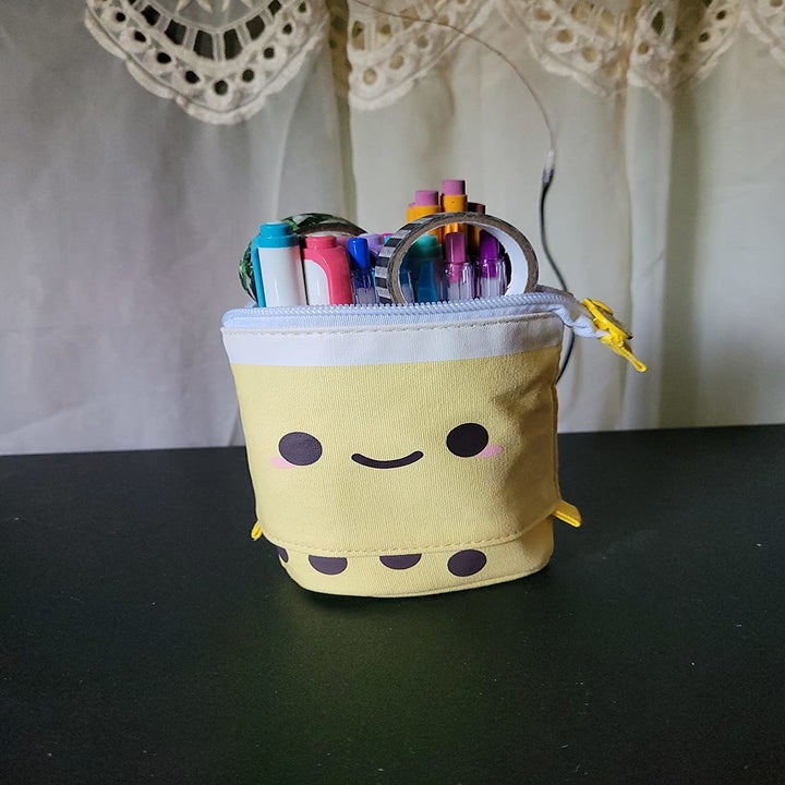 reviewer image of pens inside the yellow bubble tea pencil holder
