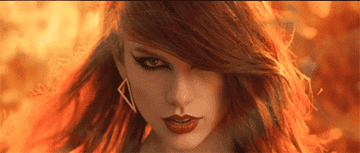 Taylor Swift wearing eyeliner emerging from flames