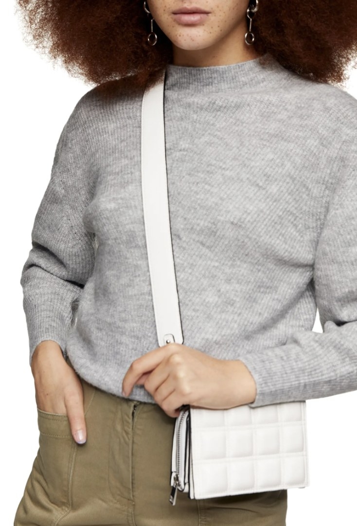 model wearing sweater in grey
