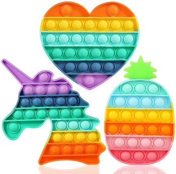 Three popping toys shaped in heart, unicorn and pineapple shapes