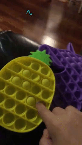 Reviewer's video showing them popping the pineapple and unicorn toy