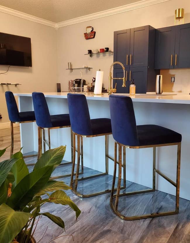 Reviewer's navy blue and gold bar stools are shown in the kitchen