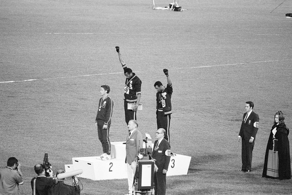 Peter Norman with two other athletes who are giving the black power salute