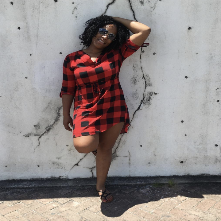 reviewer wearing plaid dress with sandals 