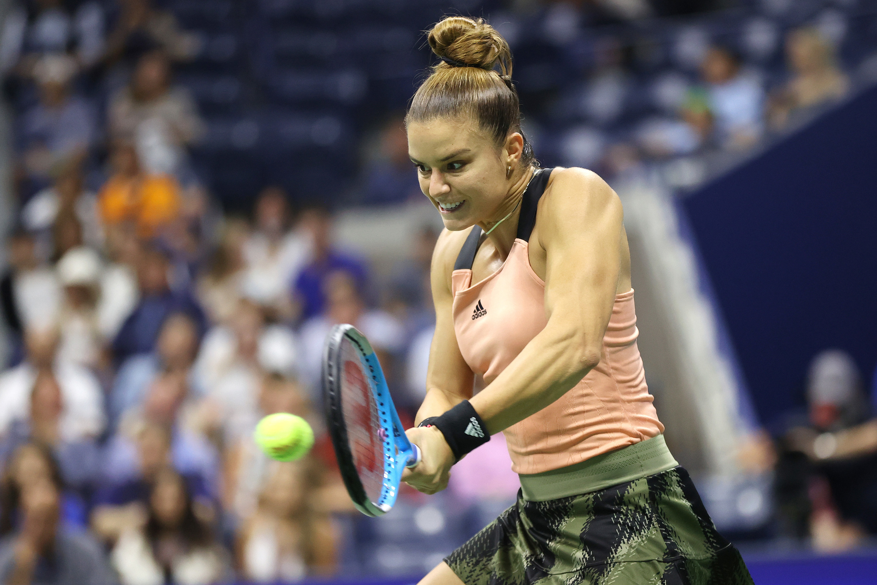 Maria Sakkari hits backhand while muscles flex