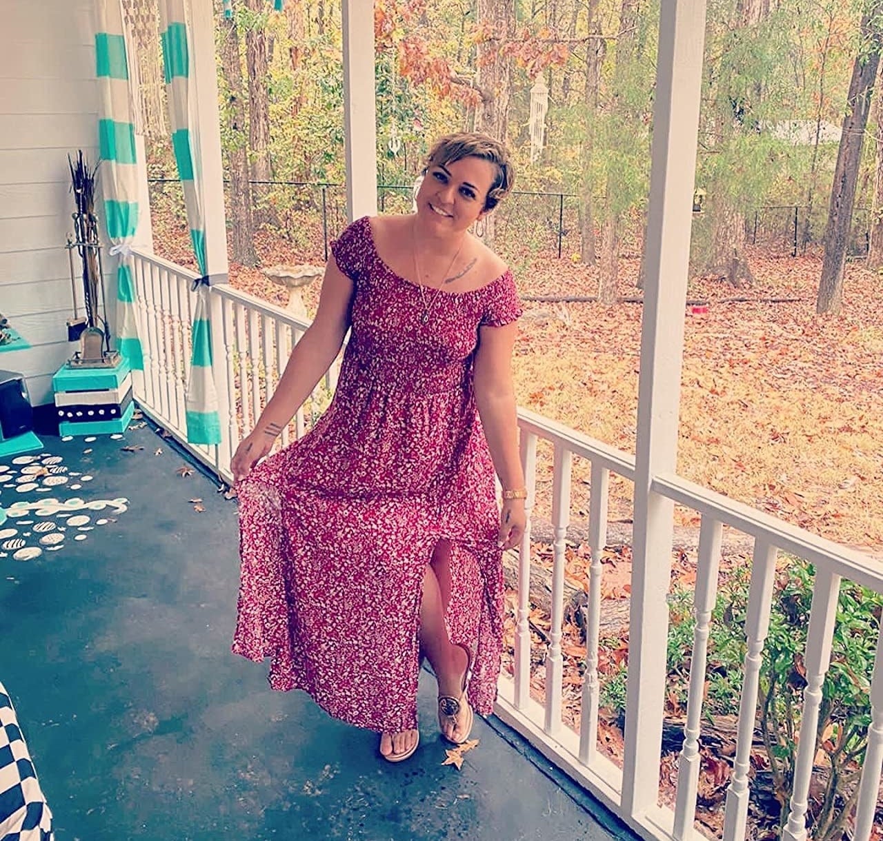 reviewer wearing the dress in red on a porch