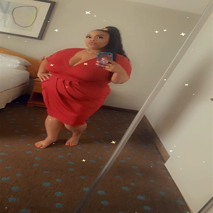 reviewer wearing the dress in red 