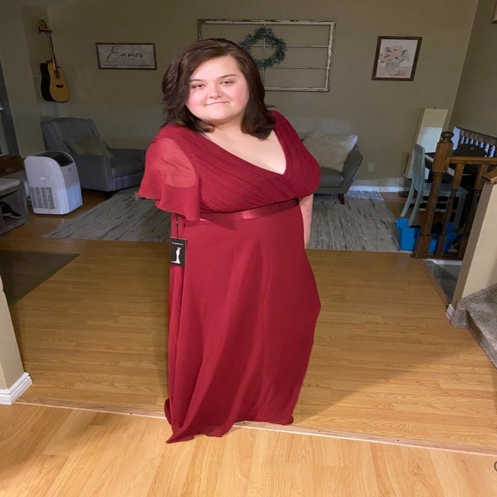 reviewer wearing the dress in red