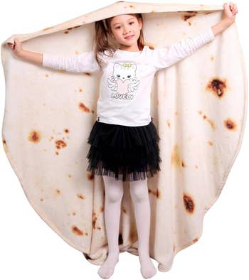 A child holding the tortilla blanket