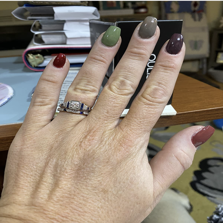 Reviewer with fingers painted in different shades of red, green, brown, and gray