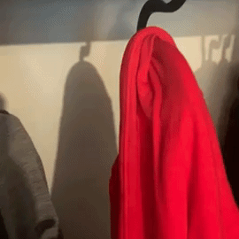 GIf of BuzzFeeder removing hoodie from hanger