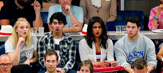 Sophie, Joe, Priyanka, and Nick sitting together and making expressive faces