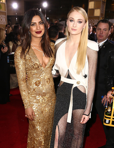 Priyanka and Sophie standing together and dressed for a gala event