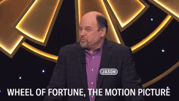 Jason Alexander waves his hand through the air. The caption reads, &quot;Wheel of Fortune, the motion picture&quot;