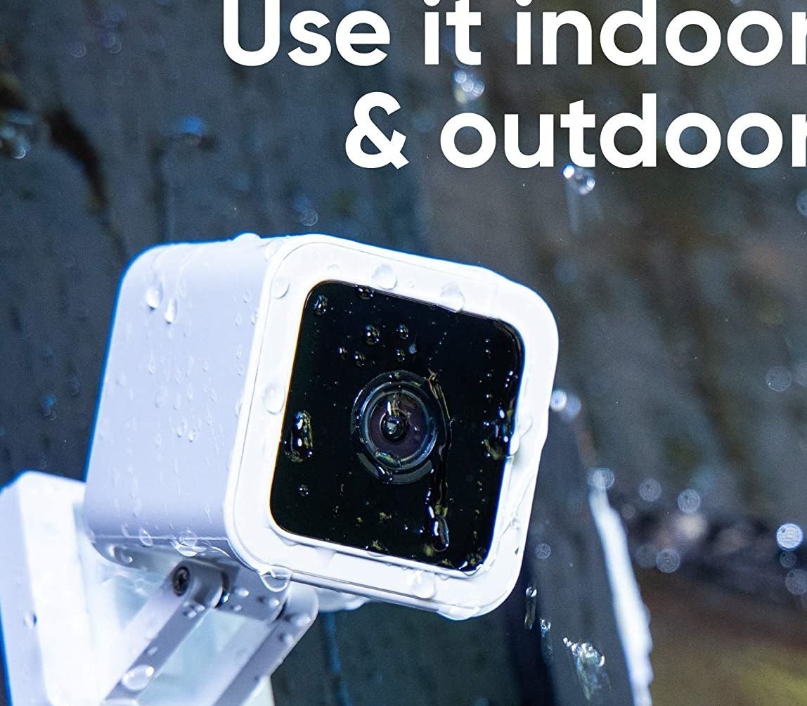 A mini security camera covered in rain water