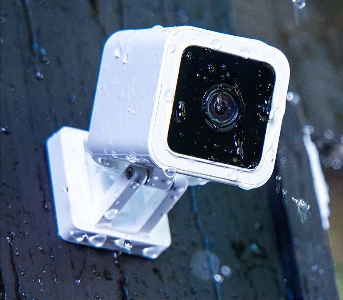 A mini security camera covered in rain water