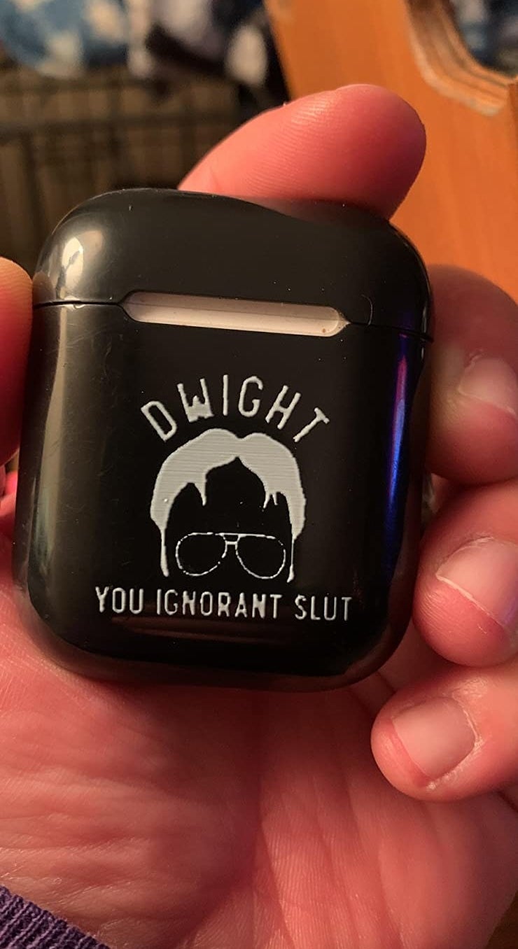 reviewer holding black case printed with "Dwight you ignorant slut" and silhouette of dwight's face
