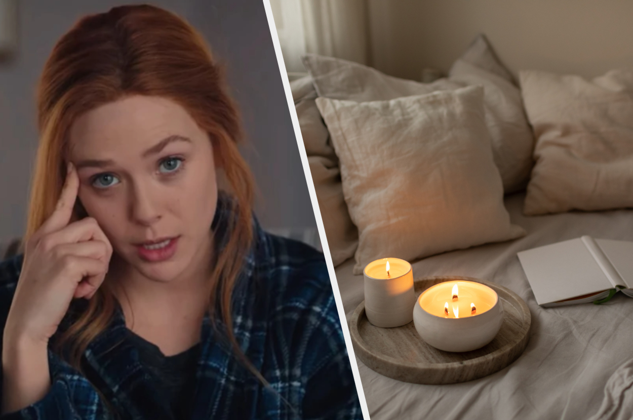 Wanda Maximoff sits with her head leaning on her finger and a two lit candles sit on top of a bed