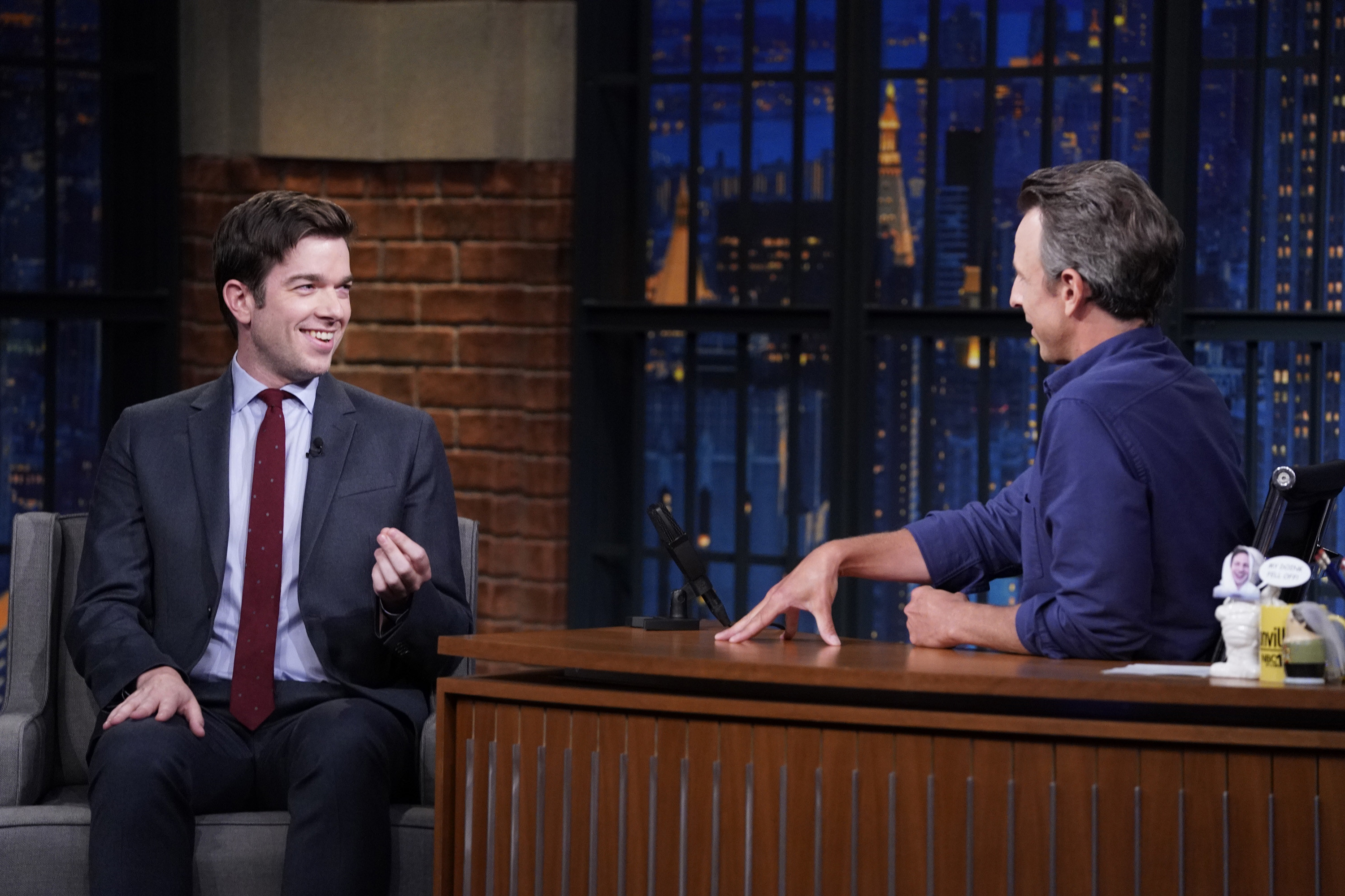 John Mulaney talking with Seth Meyers on Late Night