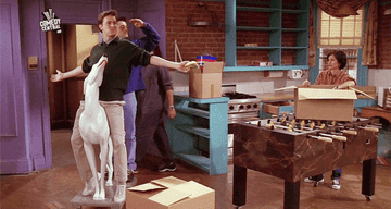 Joey and Chandler wheeling into Monica and Rachel&#x27;s apartment on the dog statue