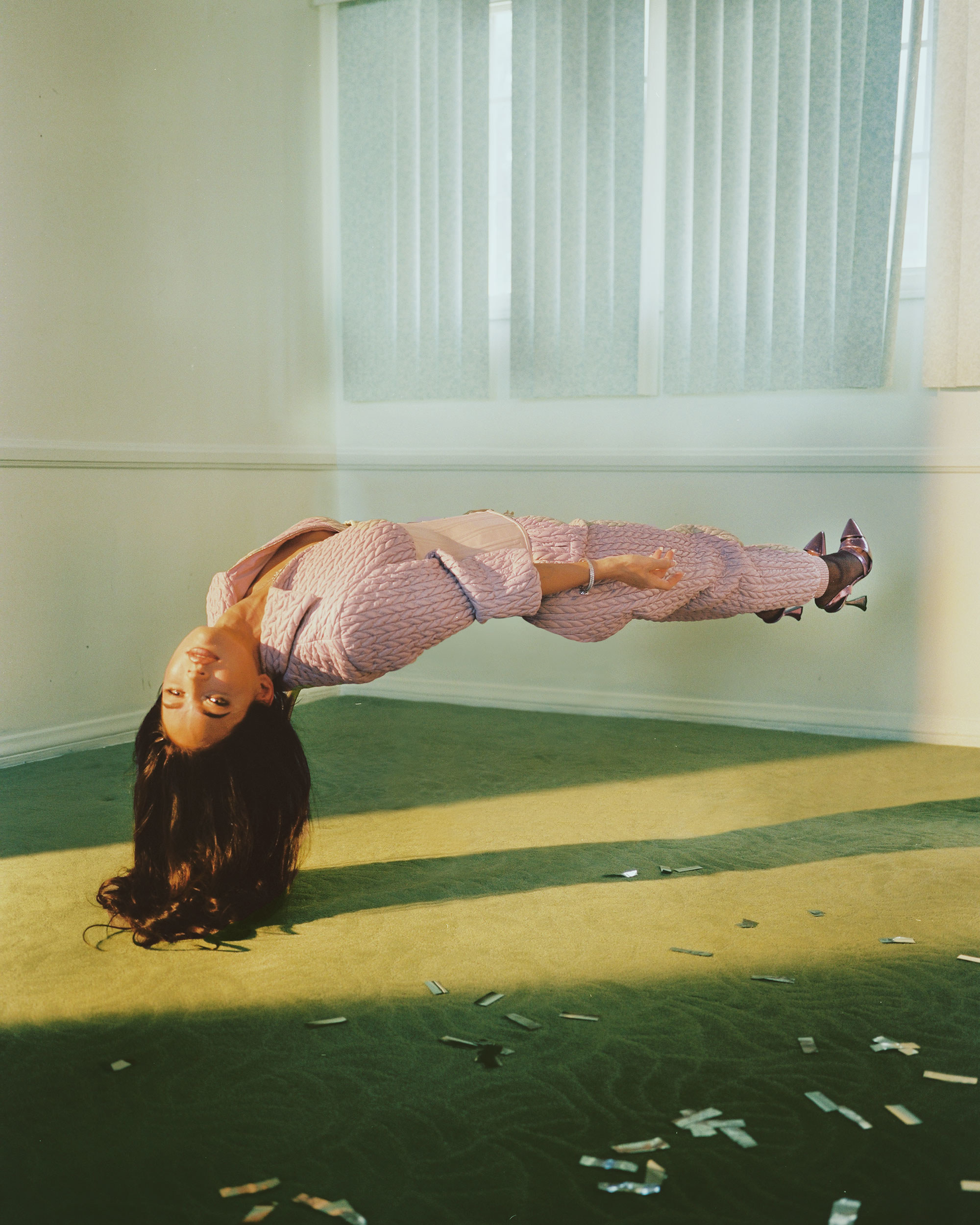 Megan levitating while wearing a pantsuit and heels