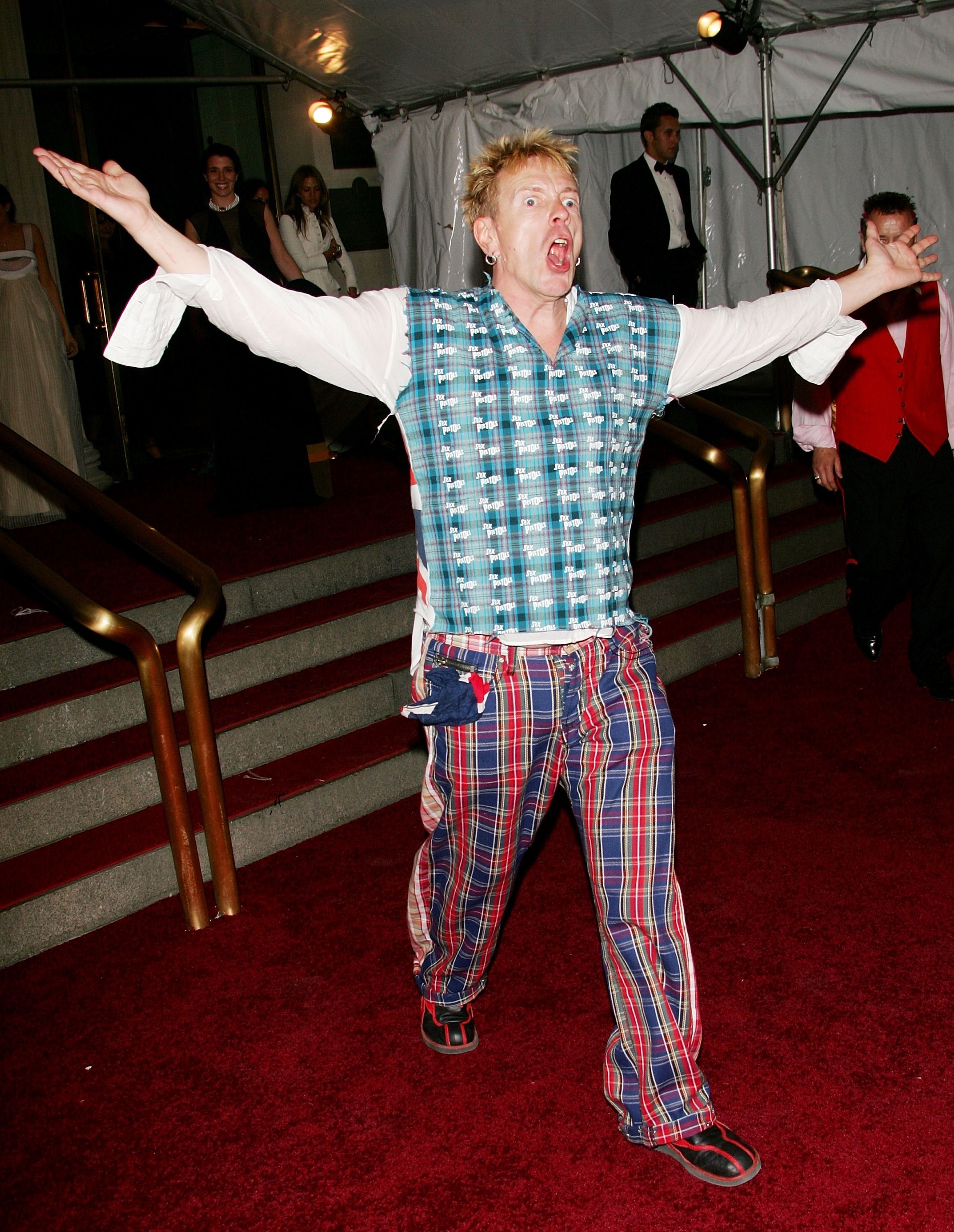 John Lydon screaming with his arms waving in the air