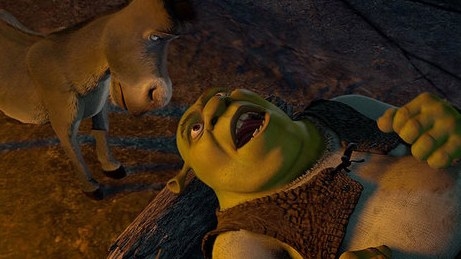 Shrek lies on a log talking to Donkey who is standing above him