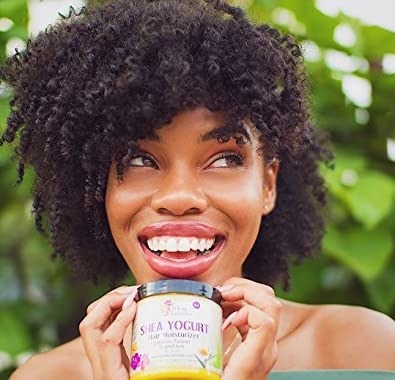a person holding the container of shea yogurt