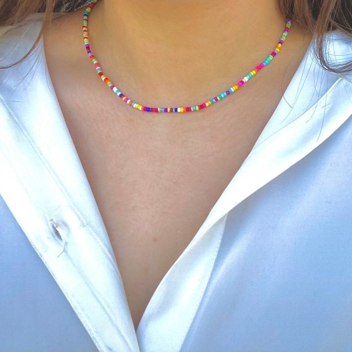 model in delicate beaded necklace