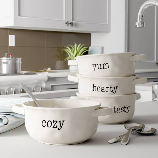 the four white bowls with the words 