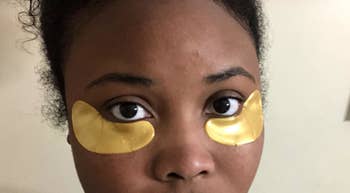 reviewer wearing the gold curved eye masks 