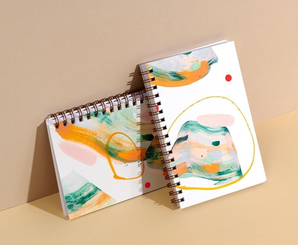 A pair of hand-painted notebooks